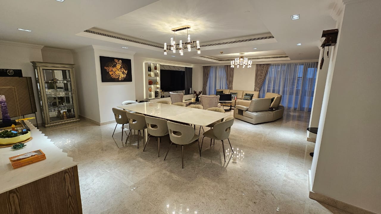 Open plan living and dining interior in a Dubai apartment with marble flooring